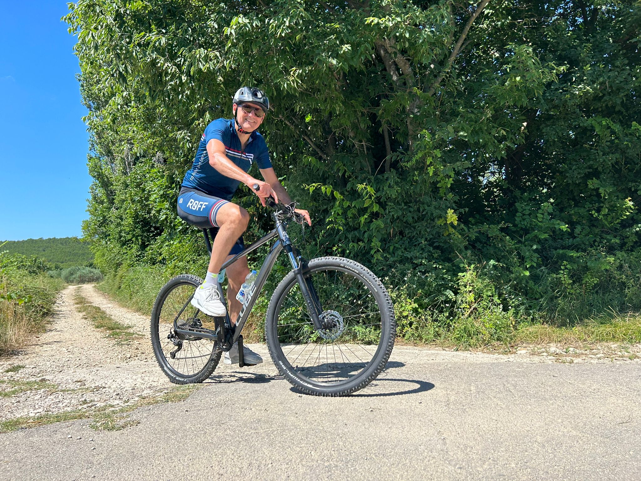 Happy cyclist in greenery